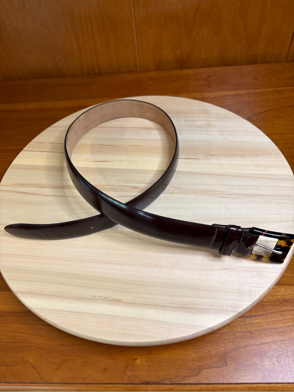 Harold Powell leather dress belt features a glossy shine and tortoise buckle
